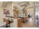 Open-concept kitchen with bar seating, granite countertops, and modern stainless steel appliances at 670 Du Fort Ave, Henderson, NV 89002