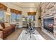 Living room showcasing fireplace and stone accent wall and large windows at 670 Du Fort Ave, Henderson, NV 89002