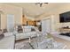 Inviting living room with plush seating, neutral walls and a decorative glass coffee table at 670 Du Fort Ave, Henderson, NV 89002