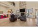 Open-concept living room with fireplace and French doors at 670 Du Fort Ave, Henderson, NV 89002