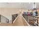 Bright and open loft area featuring decorative iron railings and access to the staircase at 670 Du Fort Ave, Henderson, NV 89002