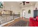 Spacious loft area with ornamental iron railings, a comfortable sofa, and an open floor plan at 670 Du Fort Ave, Henderson, NV 89002