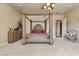 A large main bedroom featuring a canopy bed and seating area at 670 Du Fort Ave, Henderson, NV 89002