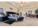 A main bedroom with a queen bed, sitting area, and decorative wall art at 670 Du Fort Ave, Henderson, NV 89002
