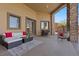 Covered patio area with comfortable seating, stone accents and an open layout at 670 Du Fort Ave, Henderson, NV 89002
