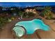 Breathtaking aerial view of the backyard featuring a large swimming pool, jacuzzi, and lush landscaping at twilight at 670 Du Fort Ave, Henderson, NV 89002