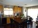 Eat-in kitchen featuring wood cabinetry, a large dining table, and bright, natural light at 6772 Oak Mist St, Las Vegas, NV 89139