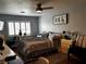 Cozy bedroom with hardwood floors, stylish decor, and a comfortable bed with natural lighting at 682 Corte Madera Ave, Henderson, NV 89015