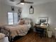 Bright bedroom with a stylish bed, vanity area, hardwood floors, and ample natural light at 682 Corte Madera Ave, Henderson, NV 89015