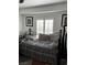 Comfortable bedroom featuring natural light, hardwood floors, and simplistic decorations at 682 Corte Madera Ave, Henderson, NV 89015
