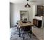 Bright dining area featuring a modern light fixture, stylish rug, and a sleek buffet at 682 Corte Madera Ave, Henderson, NV 89015