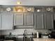 Modern kitchen with grey cabinets, subway tile backsplash, and stainless steel faucet at 682 Corte Madera Ave, Henderson, NV 89015