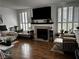 Cozy living room with fireplace, wood floors, plantation shutters, and stylish decor at 682 Corte Madera Ave, Henderson, NV 89015