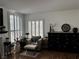 Bright living room featuring plantation shutters, a decorative fireplace and accent chair at 682 Corte Madera Ave, Henderson, NV 89015
