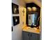 Stylish powder room with modern fixtures, decorative mirror, and sconce lighting at 682 Corte Madera Ave, Henderson, NV 89015
