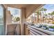 Balcony view with parking and lush palm trees for a serene outdoor experience at 6861 Tamarus St # 203, Las Vegas, NV 89119
