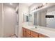 Functional bathroom with a large mirror, built-in cabinets, and washer/dryer for convenience at 6861 Tamarus St # 203, Las Vegas, NV 89119