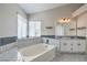Bright bathroom with soaking tub, double sinks, and ample counter space at 7633 Raven Hills Dr, Las Vegas, NV 89149