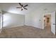 Spacious bedroom featuring a ceiling fan, neutral paint, and plush carpeting at 7633 Raven Hills Dr, Las Vegas, NV 89149