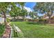 A lush community park with mature trees, manicured lawns, and a comfortable park bench at 7633 Raven Hills Dr, Las Vegas, NV 89149