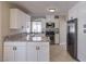 Modern kitchen with white cabinets, granite countertops, and stainless steel appliances at 7633 Raven Hills Dr, Las Vegas, NV 89149