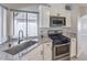 Well-lit kitchen with stainless steel appliances and granite countertops at 7633 Raven Hills Dr, Las Vegas, NV 89149