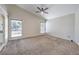 Large living area with carpet and great natural light from two large windows at 7633 Raven Hills Dr, Las Vegas, NV 89149