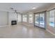 Bright living room with fireplace, tile floors, and view of the backyard pool at 7633 Raven Hills Dr, Las Vegas, NV 89149