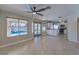 Open-concept living area with tile floors, flowing into the kitchen with white cabinets and stainless appliances at 7633 Raven Hills Dr, Las Vegas, NV 89149
