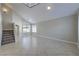 Spacious living room featuring tile floors and stairs at 7633 Raven Hills Dr, Las Vegas, NV 89149