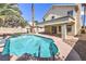 Relaxing backyard pool with a diving board and covered patio, perfect for enjoying sunny days at 7633 Raven Hills Dr, Las Vegas, NV 89149