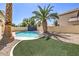 Backyard pool and palm tree create a desert oasis feel at 7633 Raven Hills Dr, Las Vegas, NV 89149
