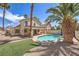 Inviting backyard with a private pool, palm trees, and lush landscaping at 7633 Raven Hills Dr, Las Vegas, NV 89149
