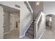 Bright entryway showcasing a carpeted staircase and arched doorway to the kitchen at 7633 Raven Hills Dr, Las Vegas, NV 89149