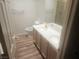 Bathroom featuring double sinks, wooden cabinets, toilet, and shower at 7657 Velvet Mist St, Las Vegas, NV 89131
