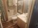 Bathroom featuring a tub with shower, toilet, sink and large mirror at 7657 Velvet Mist St, Las Vegas, NV 89131