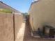 Side yard with block wall, AC, and gate, and desert landscaping at 7657 Velvet Mist St, Las Vegas, NV 89131