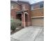 Exterior view featuring attached garage and a well-maintained landscape at 7977 Delft Blue St, Las Vegas, NV 89139