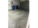 Spacious garage with a concrete floor and an updated garage door at 7977 Delft Blue St, Las Vegas, NV 89139