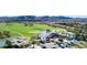 Stunning aerial view of a golf course community with manicured lawns, lush greenery, and mountain backdrop at 80 Cathedral Wash Pl, Henderson, NV 89011
