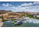 Aerial shot of a charming lakeside community with vibrant buildings, clear water, and a luxurious yacht at 80 Cathedral Wash Pl, Henderson, NV 89011