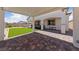 Expansive backyard featuring manicured landscaping, a lawn area, and a covered patio perfect for outdoor entertaining at 80 Cathedral Wash Pl, Henderson, NV 89011