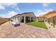 Beautiful backyard with a fire pit, outdoor seating, and artificial grass at 80 Cathedral Wash Pl, Henderson, NV 89011