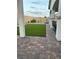 Outdoor living area with brick pavers and artificial turf grass at 80 Cathedral Wash Pl, Henderson, NV 89011