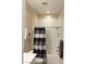Bright bathroom with shower-tub combination and modern white tile, complemented by stylish black and white curtain at 80 Cathedral Wash Pl, Henderson, NV 89011