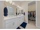 Elegant bathroom featuring dual sinks, quartz countertop, and walk-in closet at 80 Cathedral Wash Pl, Henderson, NV 89011