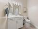 Bathroom featuring white cabinets, a large mirror, and neutral-colored walls at 80 Cathedral Wash Pl, Henderson, NV 89011