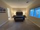 Spacious bedroom featuring a tufted headboard, bench, and serene natural light from large windows at 80 Cathedral Wash Pl, Henderson, NV 89011