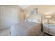 Cozy bedroom with a comfortable bed, white nightstands, and a closet at 80 Cathedral Wash Pl, Henderson, NV 89011