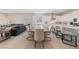 Open-concept living space featuring a long dining table and kitchen with white cabinets at 80 Cathedral Wash Pl, Henderson, NV 89011